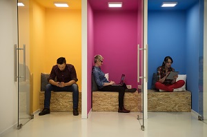 People sitting on phones and laptops.